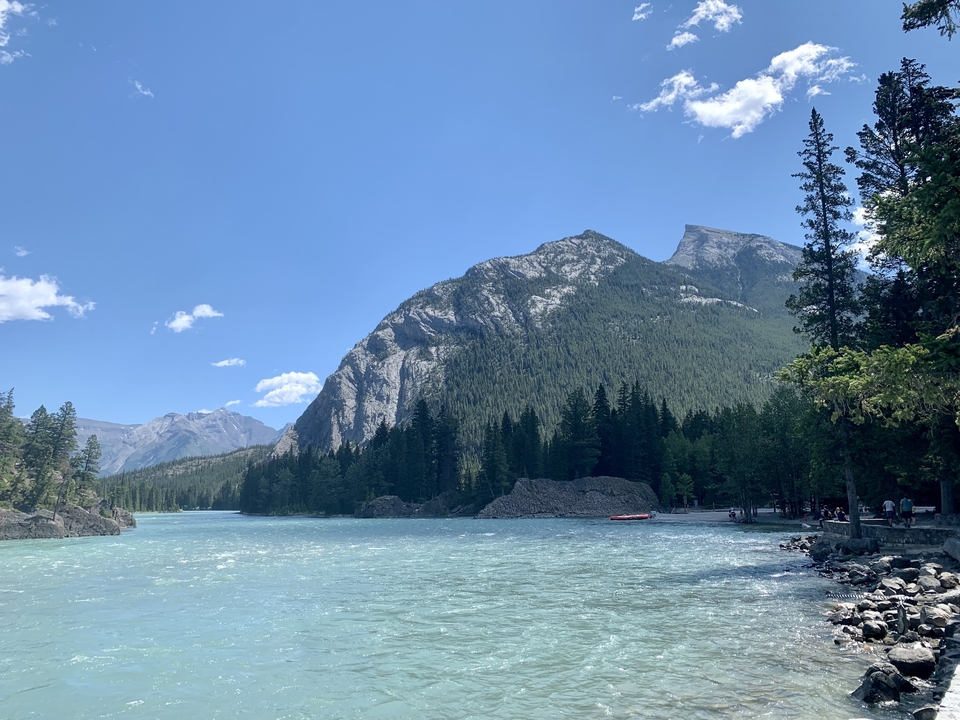 Mountain and river landscape under a clear blue sky