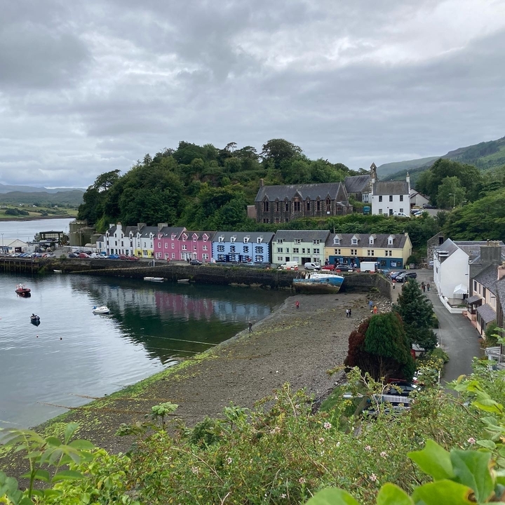 Colorful waterfront houses along a peaceful bay.