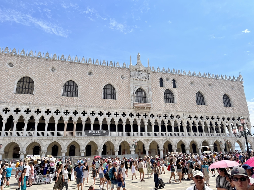 Crowded plaza in front of a historic building