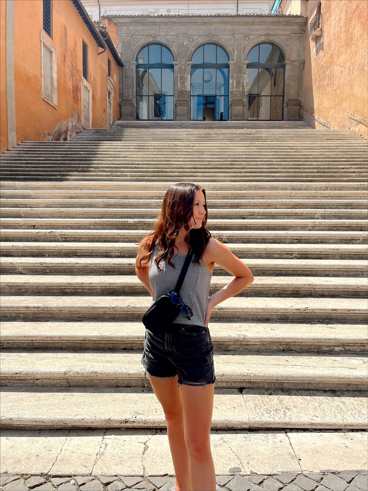 Woman posing on historic stone steps