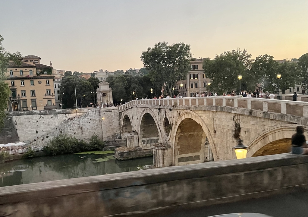 Historic stone bridge over a river in an urban setting