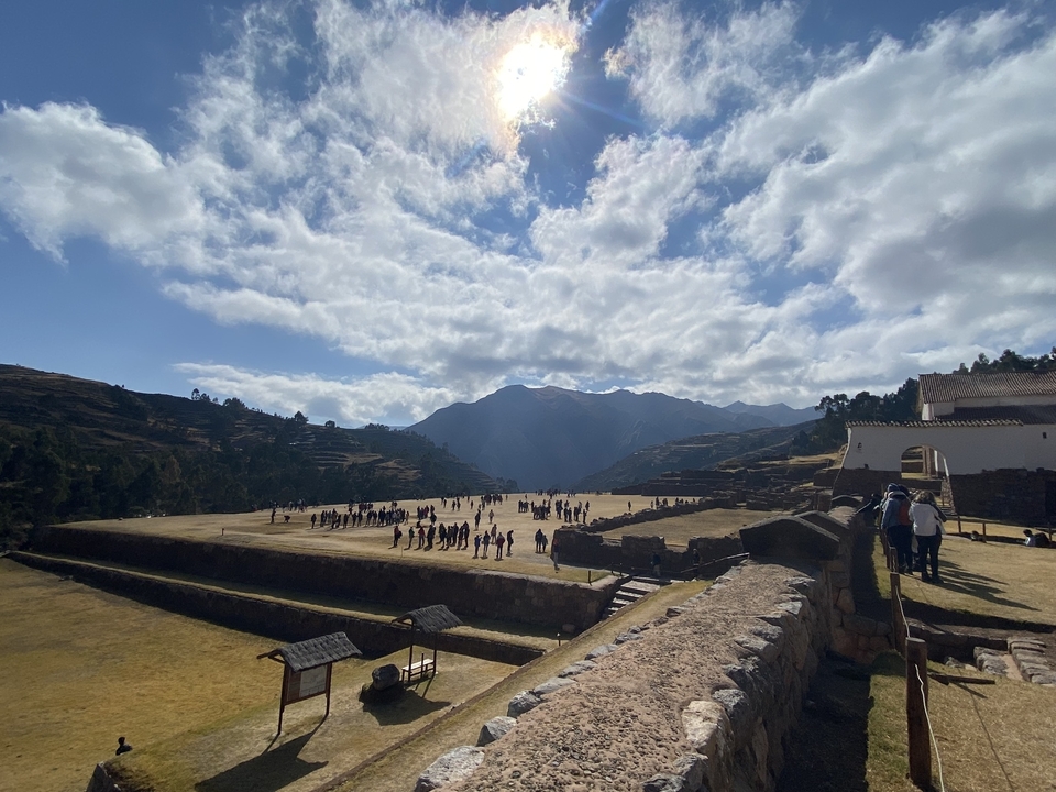 A panoramic view of an Inca archeological site with mountains.
