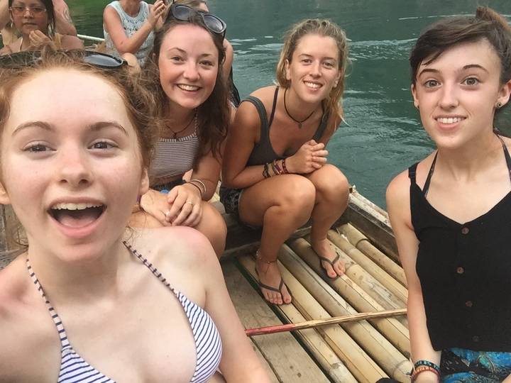 Group of people on a raft smiling at the camera.