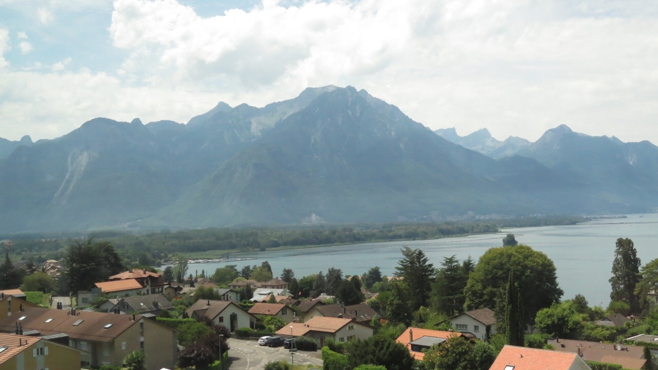 View of a small town nestled against mountain backdrop.