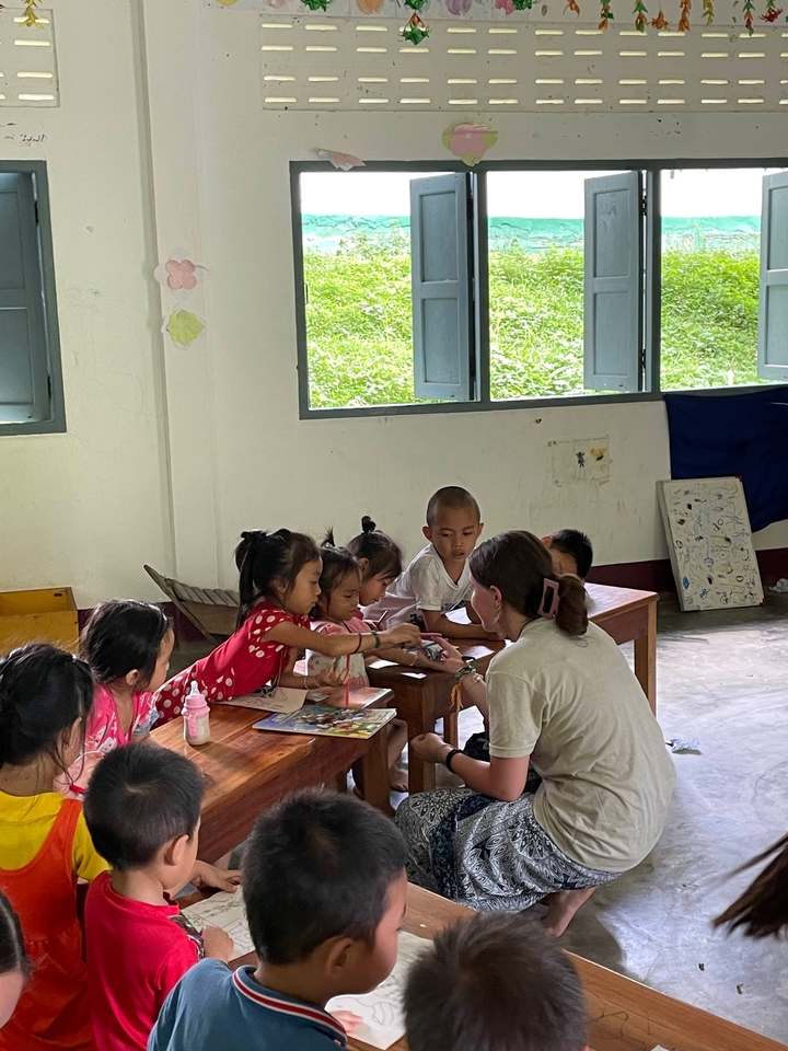 Children and teacher engaged in a classroom activity.
