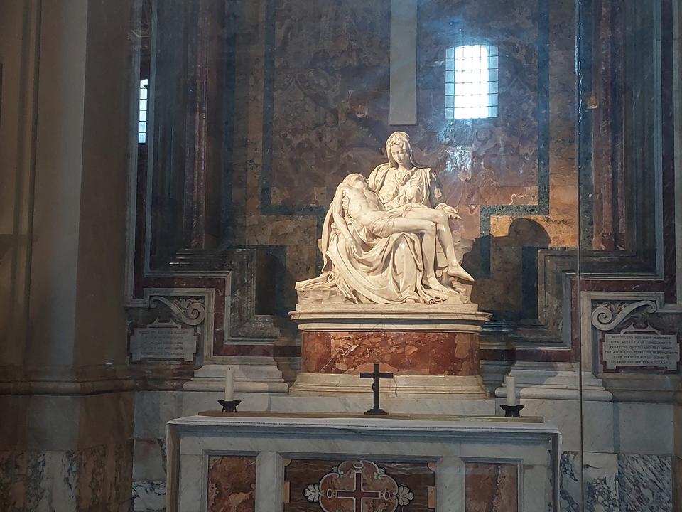 Michelangelo's Pietà in a dimly lit church.