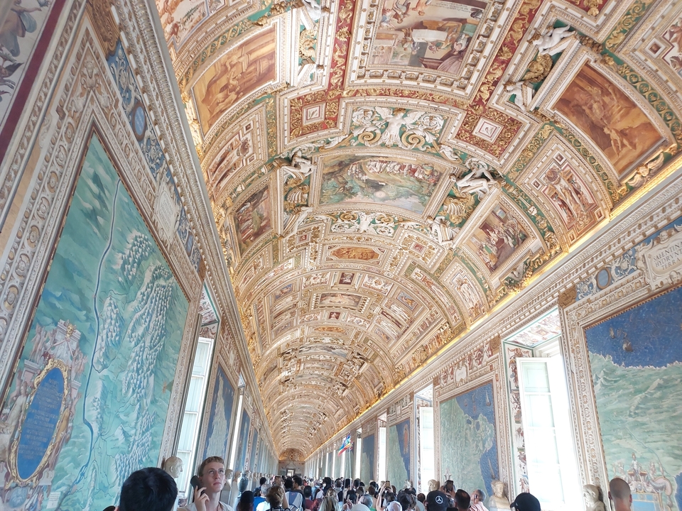 Intricately painted ceiling with religious and historical scenes.