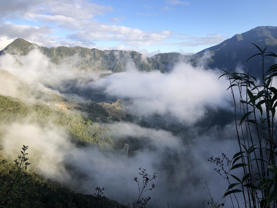 Mountain peaks visible through a cloud cover.