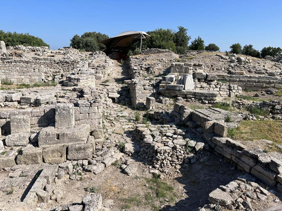 Ancient ruins with stone structures and vegetation.