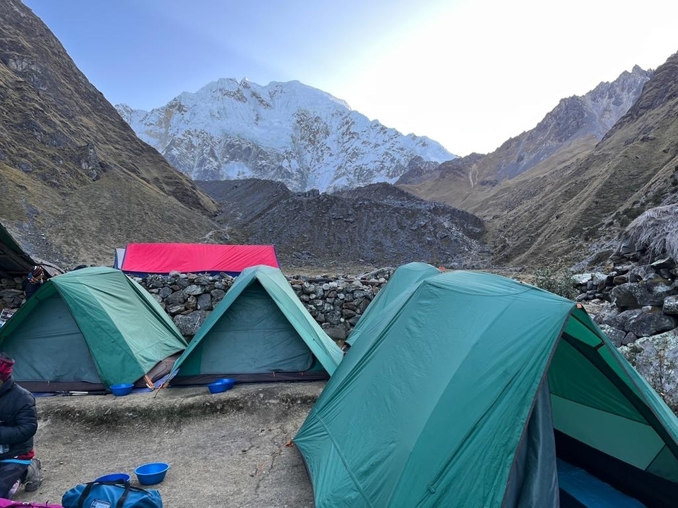 Tents set up by the mountain path for camping.