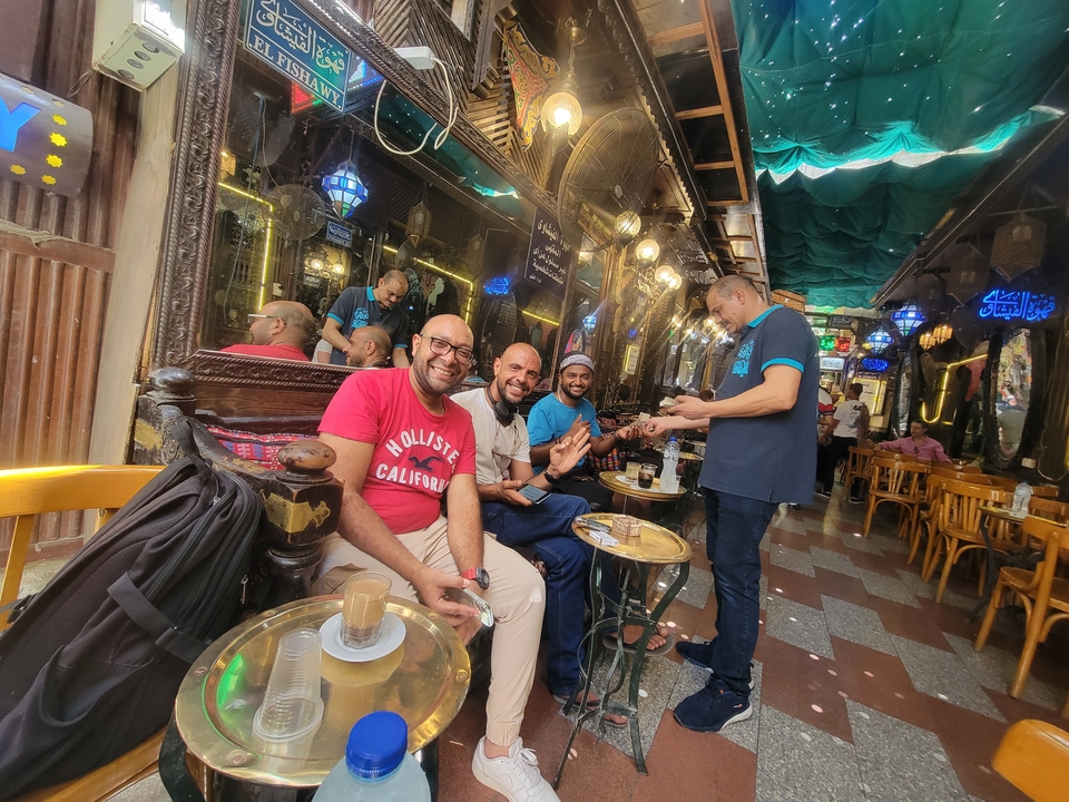 A group of men enjoying drinks in a local café.