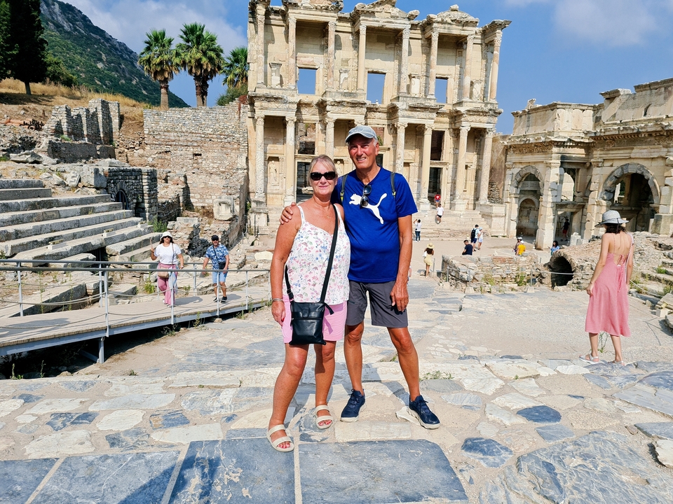 People posing in front of the ancient Library of Celsus.