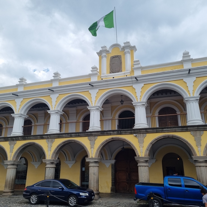 Colonial-style building with yellow walls and white columns.