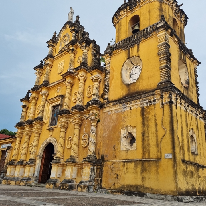 A historic yellow church with ornate details.