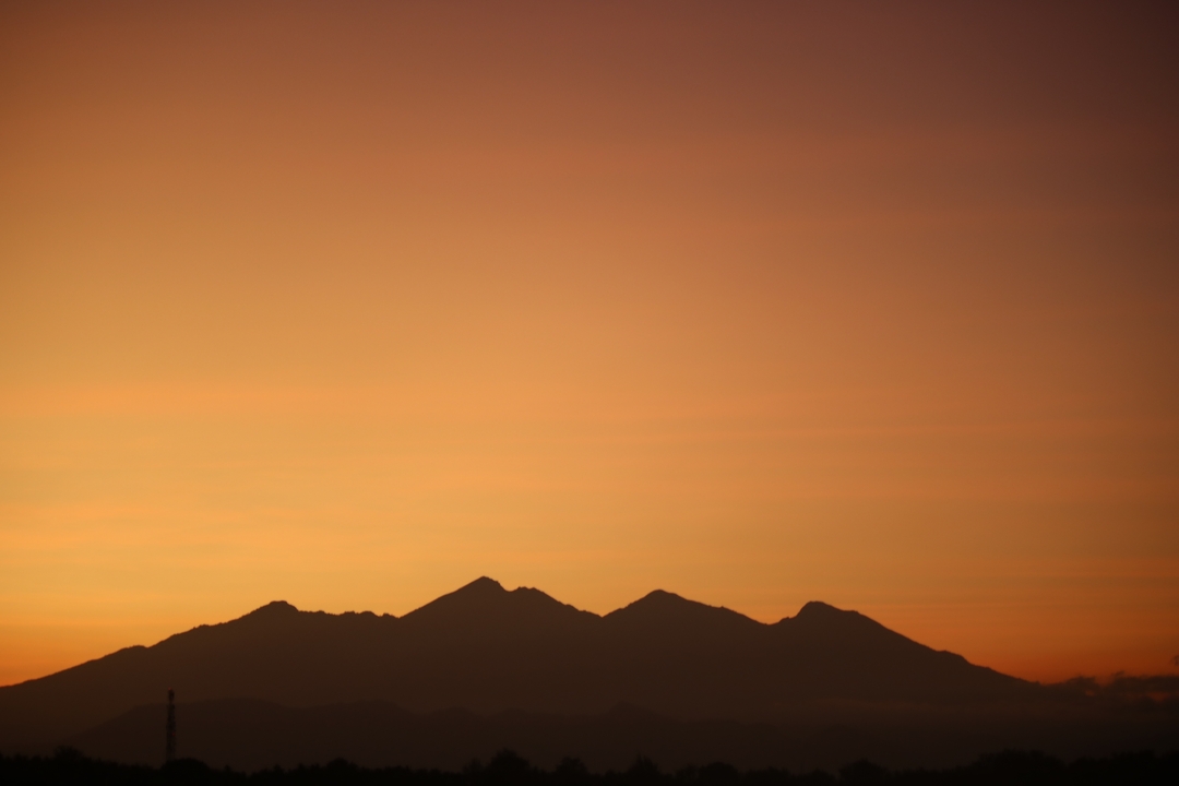 Silhouette of a mountain range during a vivid sunset.