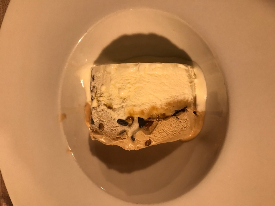 A dessert with different layers served on a white plate.
