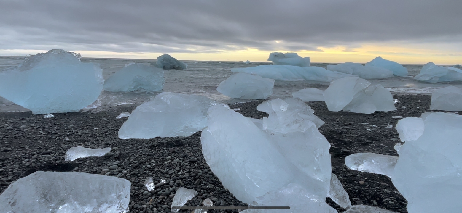 Scenic beach with ice formations and ocean view.