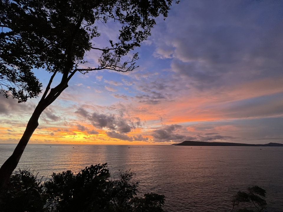 Sunset over the ocean with colorful sky.