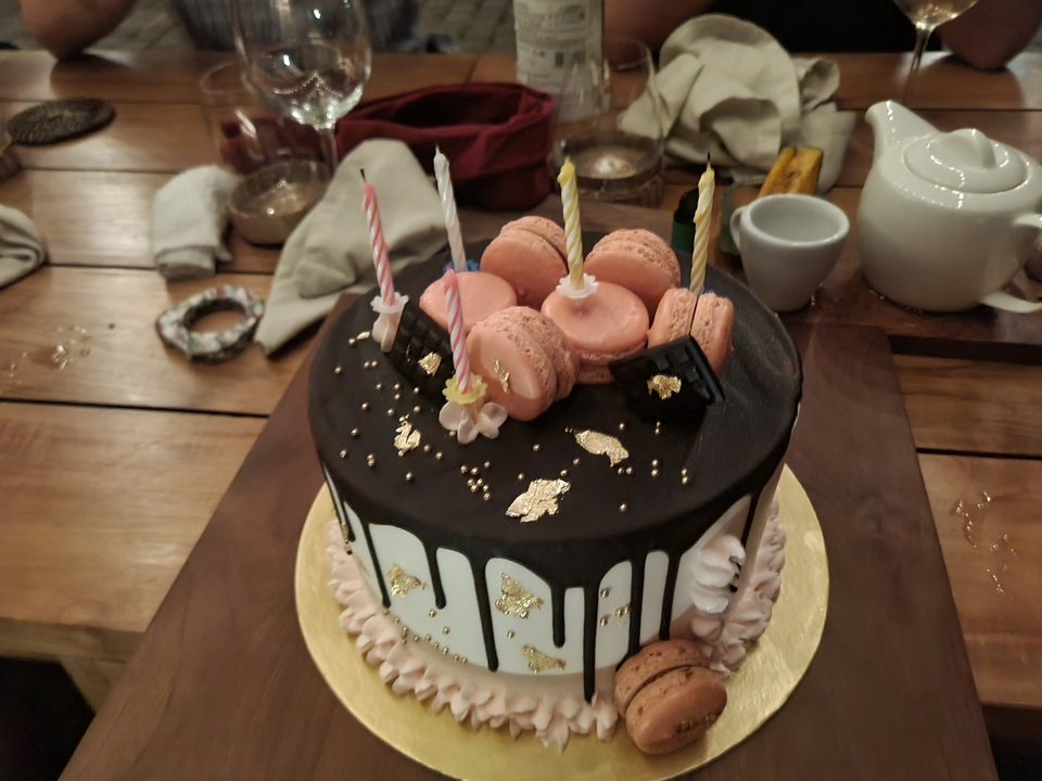 Decorative cake with macarons and candles.