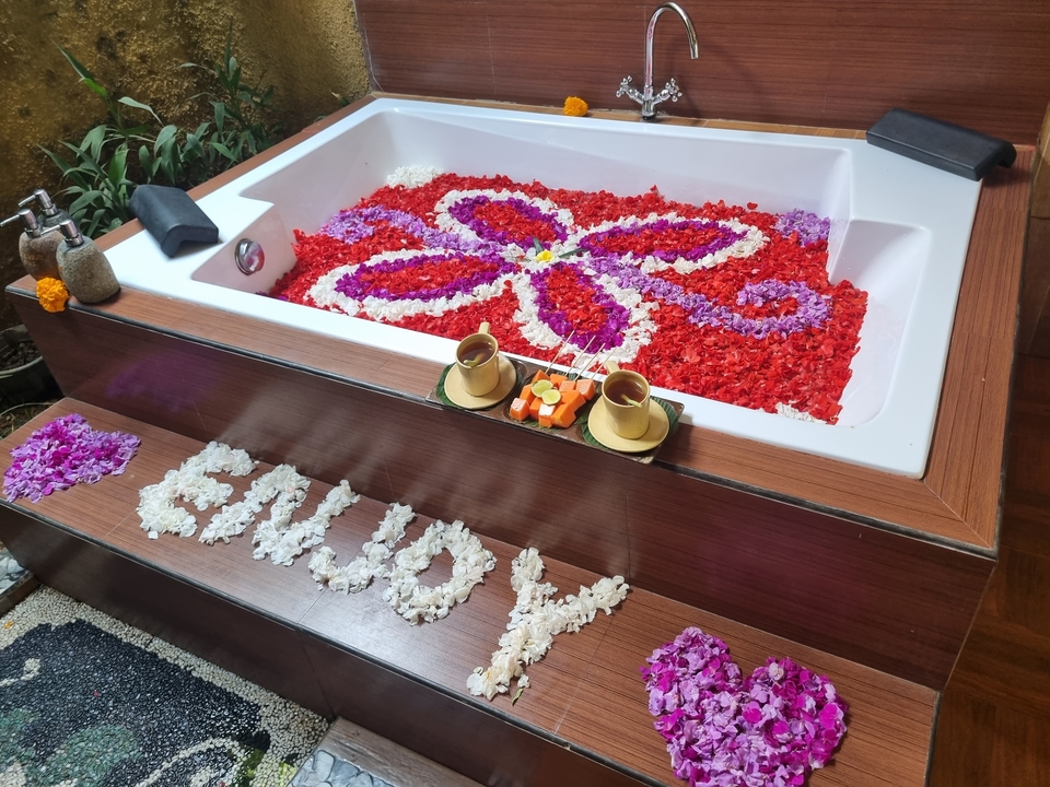 Decoratively arranged flower petals in a bathtub.