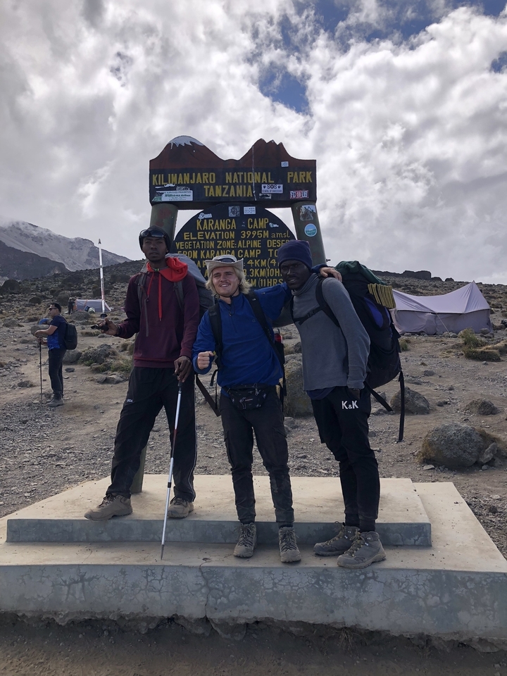 Three hikers at a mountain camp.
