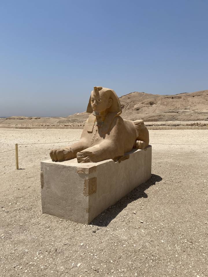 Statue of an ancient Egyptian figure in the desert.