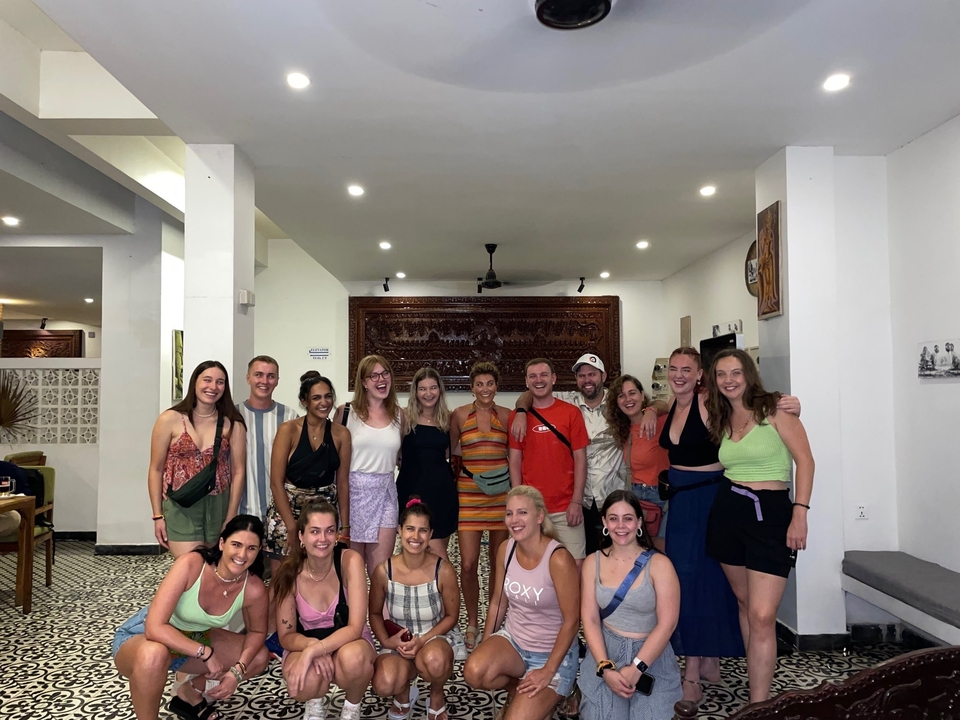 Group of people indoors posing and smiling.