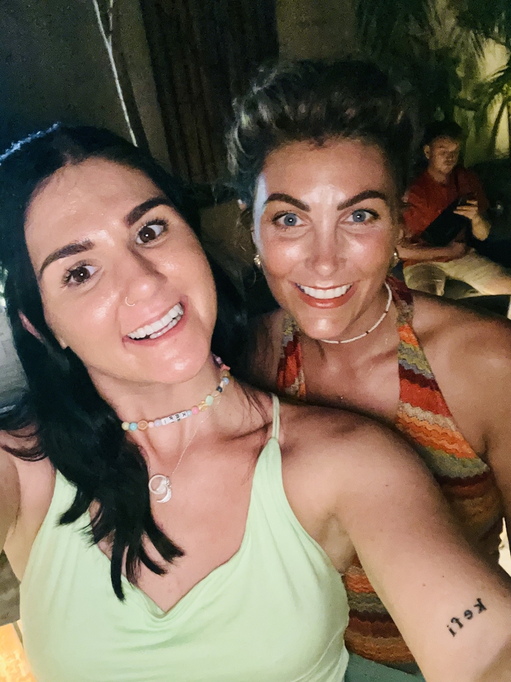 Two women smiling in the foreground.