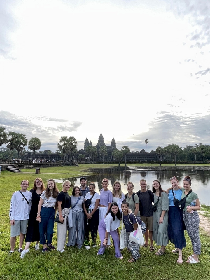 Group of people in front of Angkor Wat temple.
