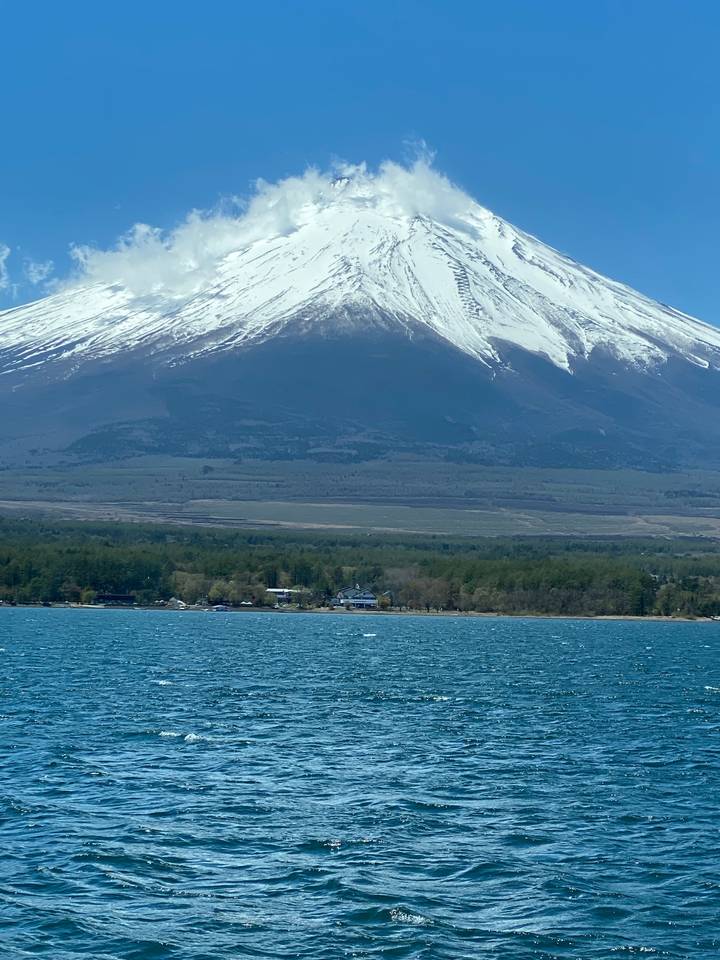 Snow-capped mountain towering over a lake.