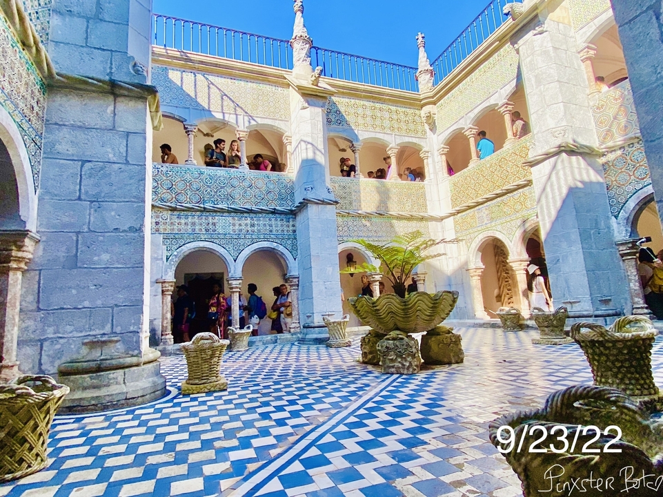Ornate courtyard with people exploring.