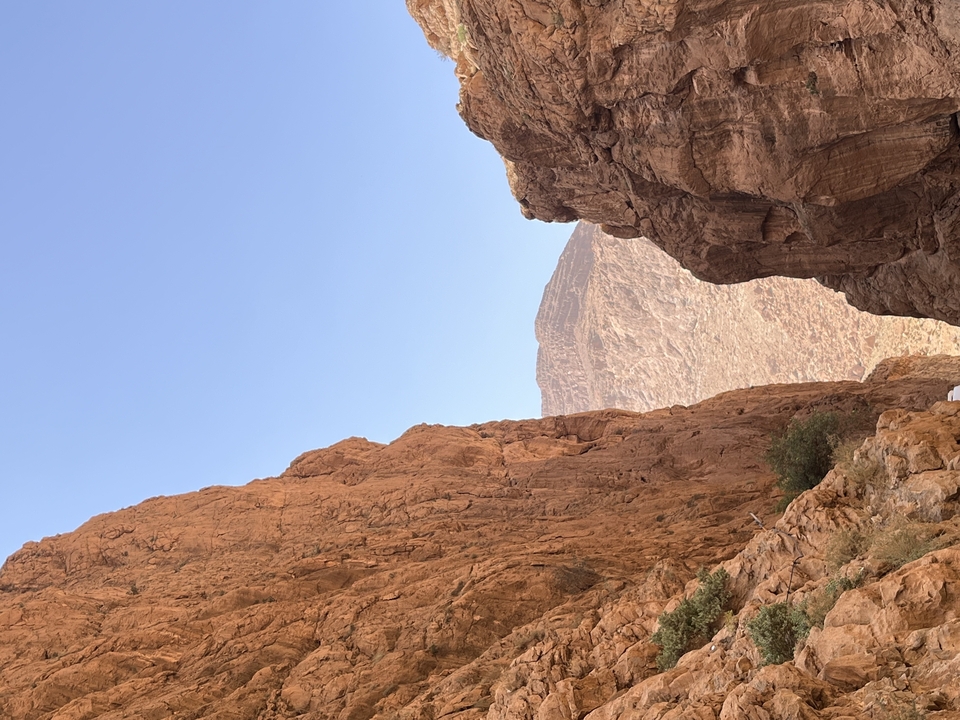 Rocky landscape with cliffs and clear blue sky.
