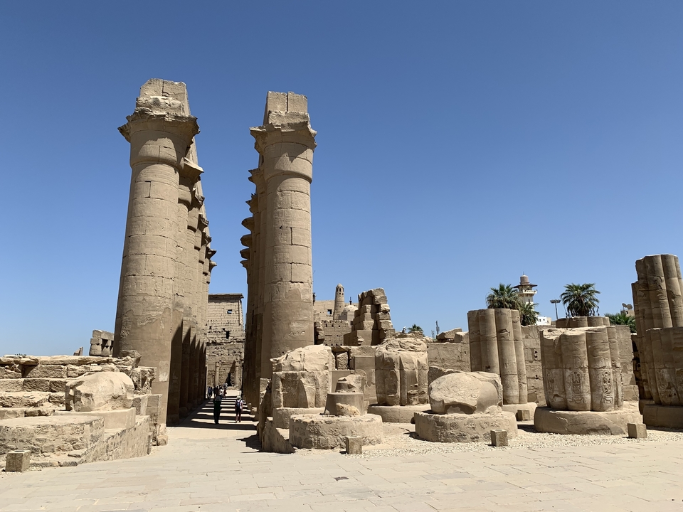 Temple ruins surrounded by scattered columns.