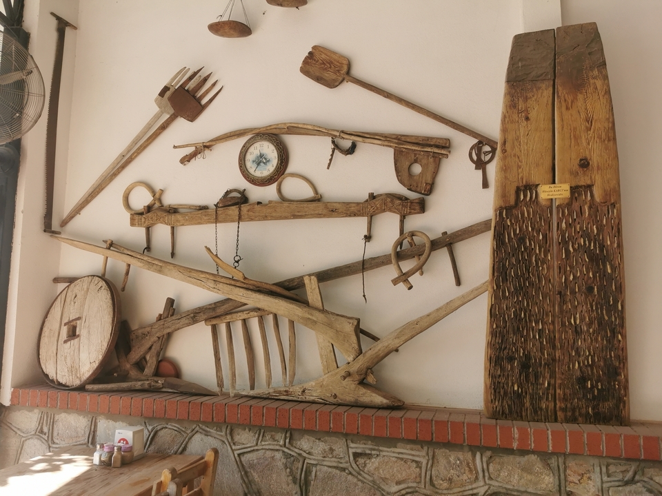 A collection of antique tools mounted on a wall.