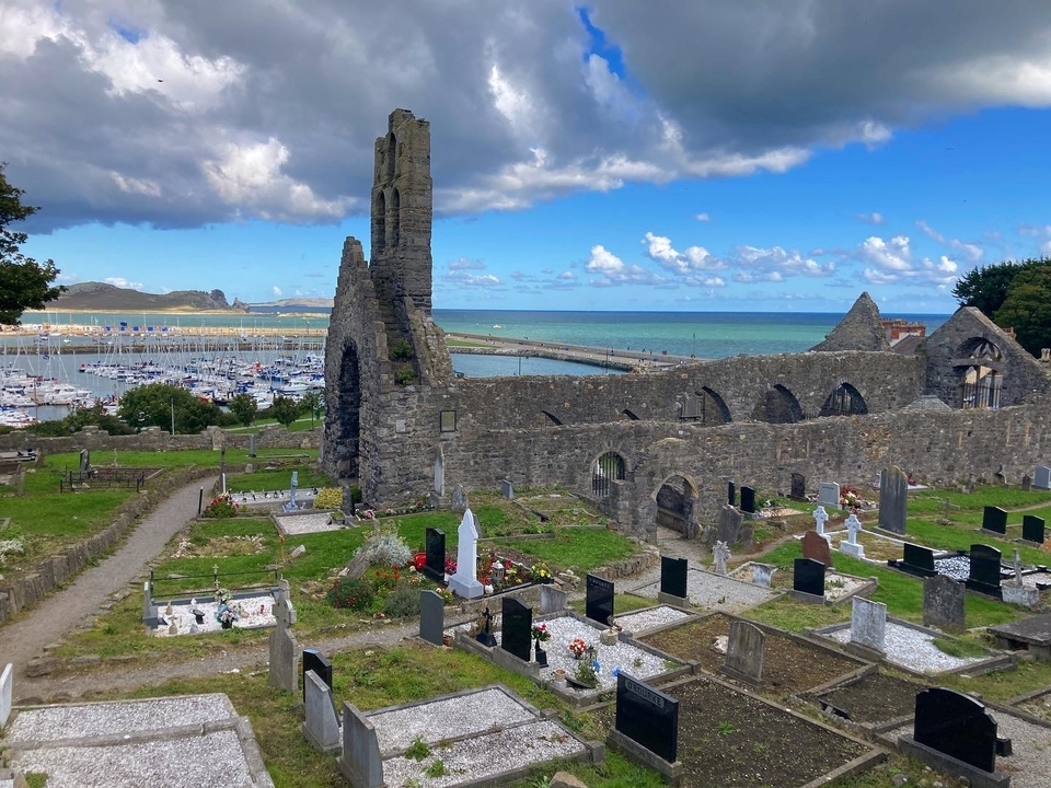 Ancient stone ruins with a marina in the background.