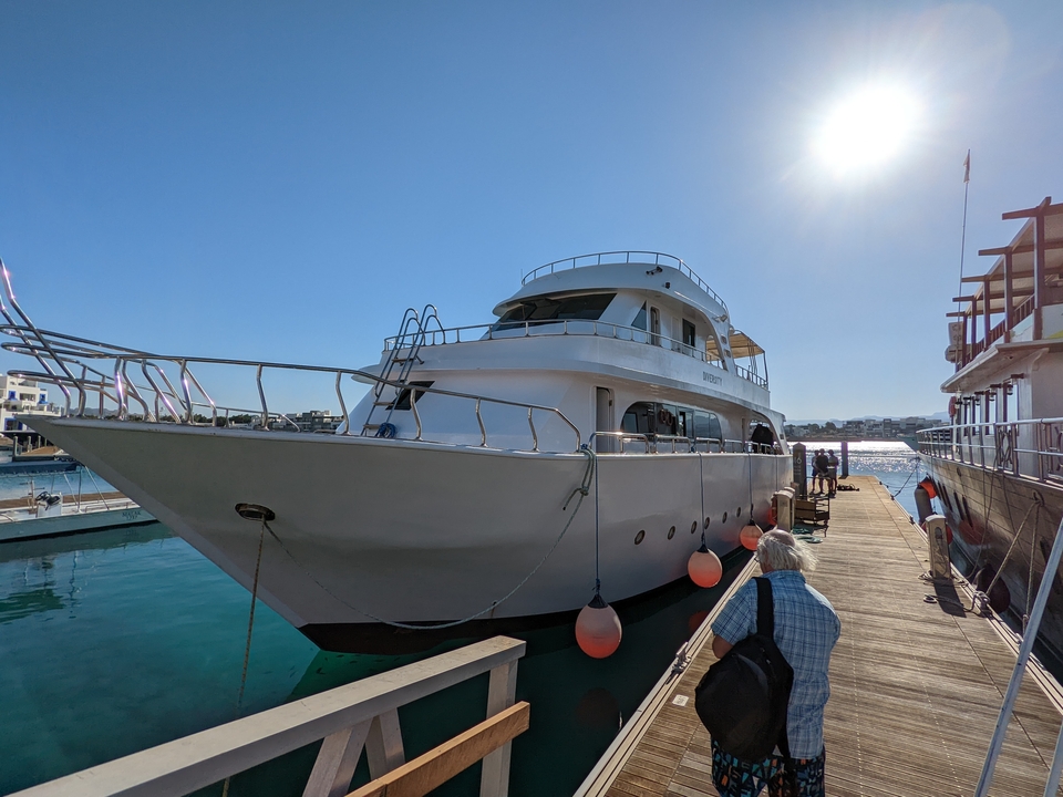 Docked yacht with people boarding