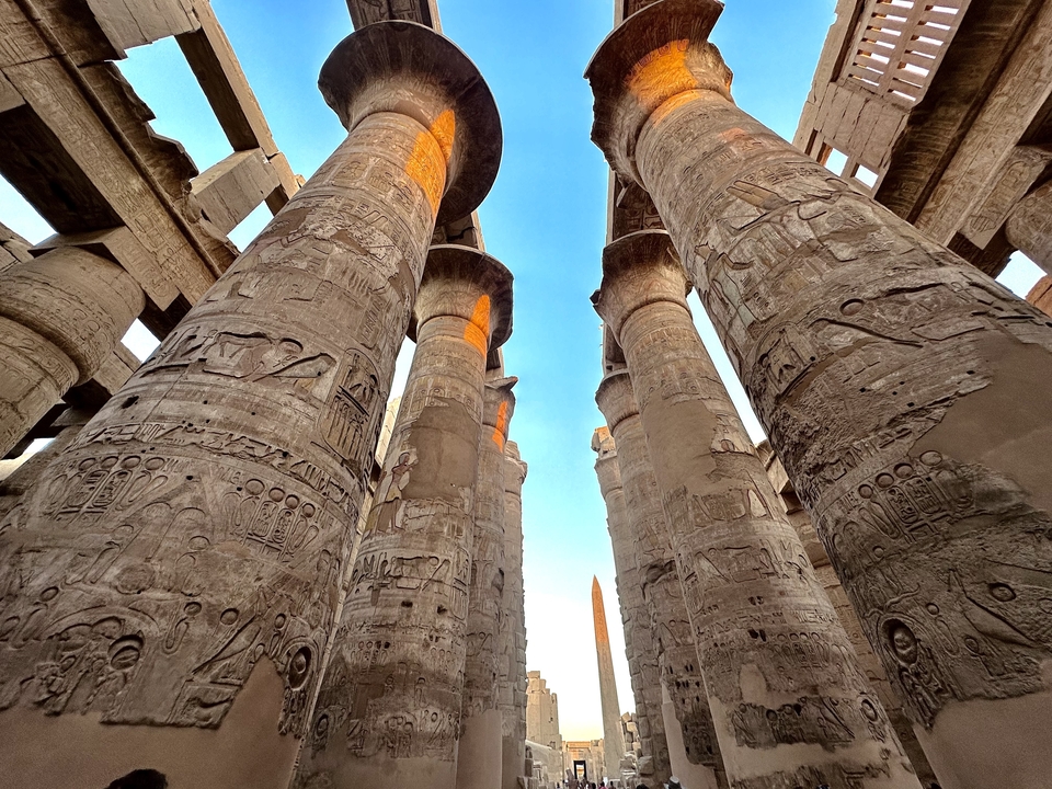 Large ancient columns with carved hieroglyphics.
