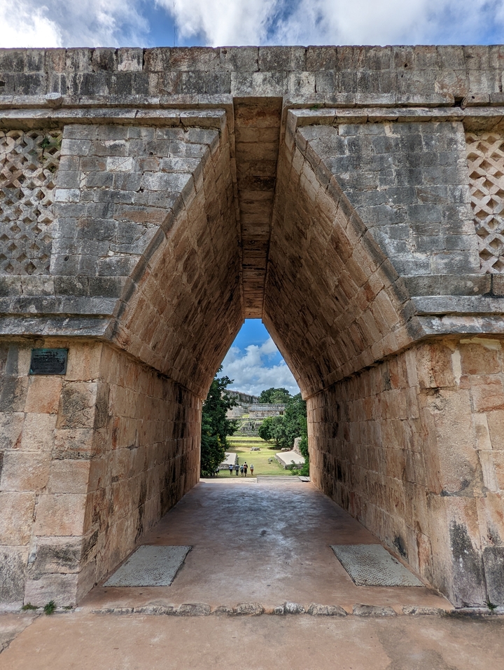 Arched stone passageway leading to ancient ruins.