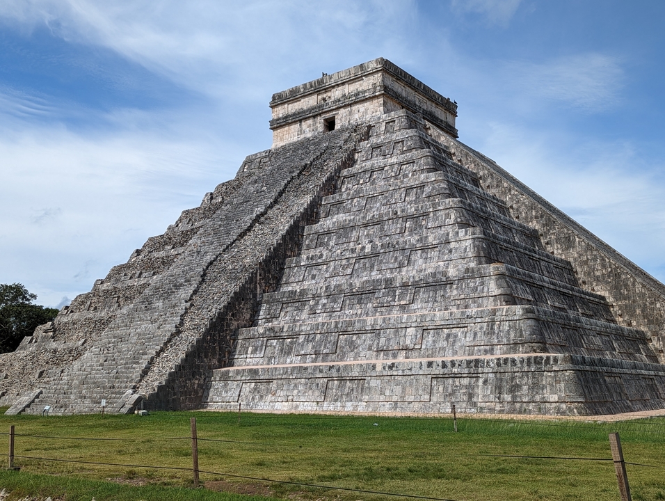 Famous pyramid at Chichen Itza under a clear blue sky.