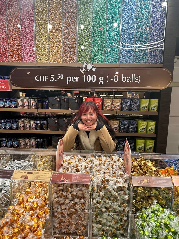 Person posing in front of a candy display.