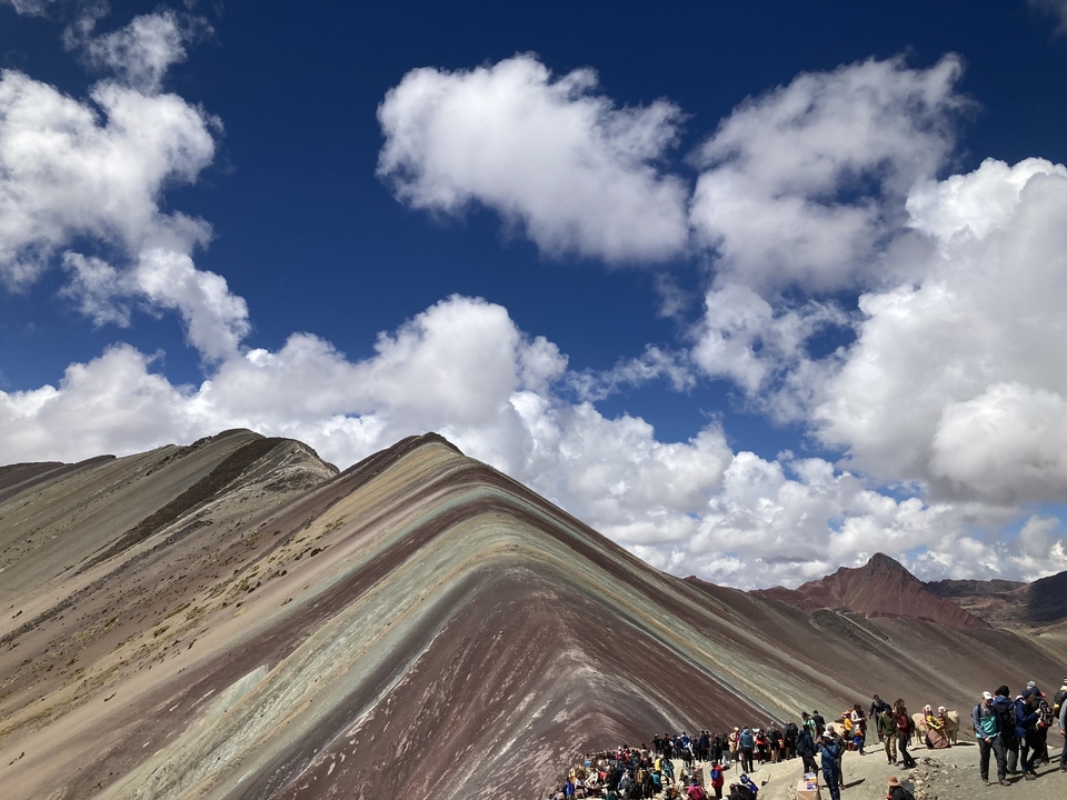 Colorful mountain landscape under a bright blue sky.
