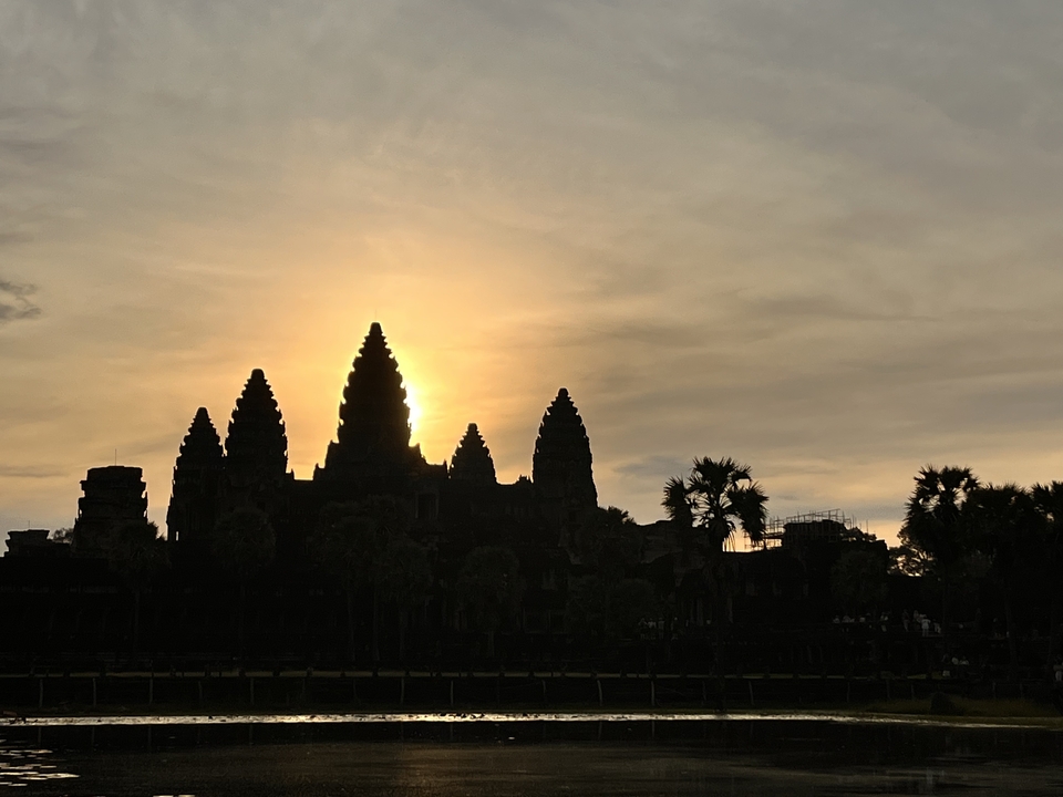 Angkor Wat silhouette against a sunset.