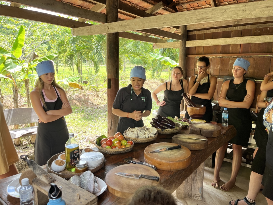 Group of tourists participating in a cooking class.