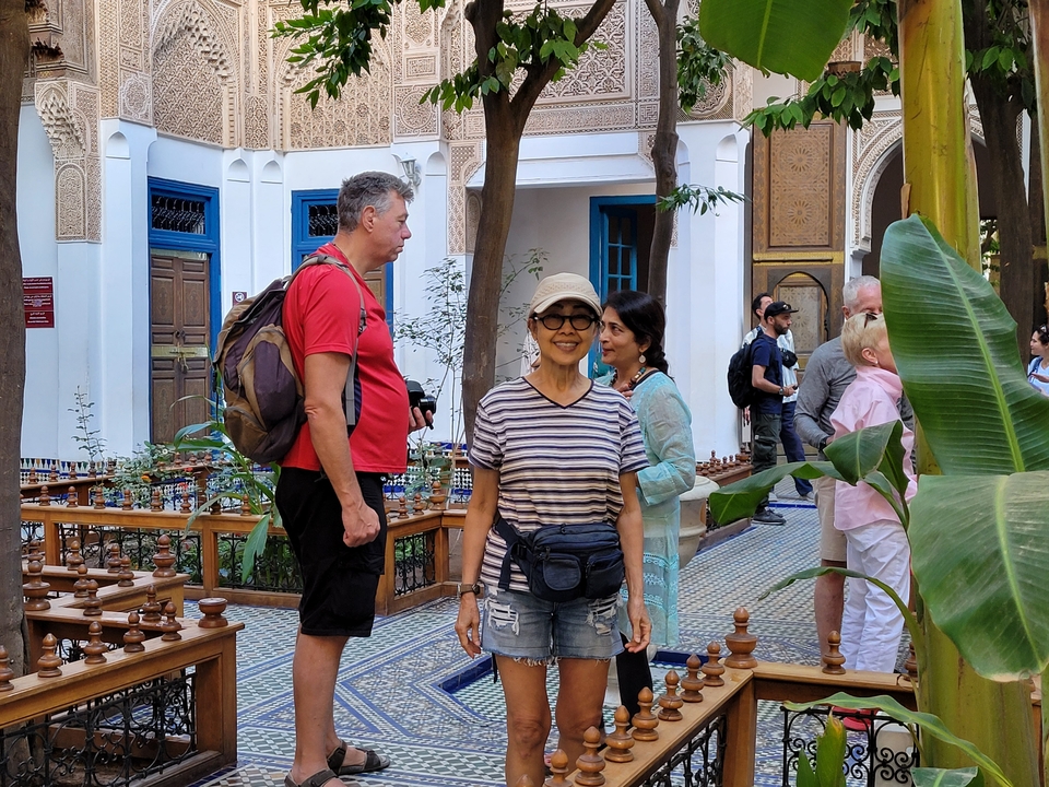 Group of tourists in a traditional Moroccan courtyard.
