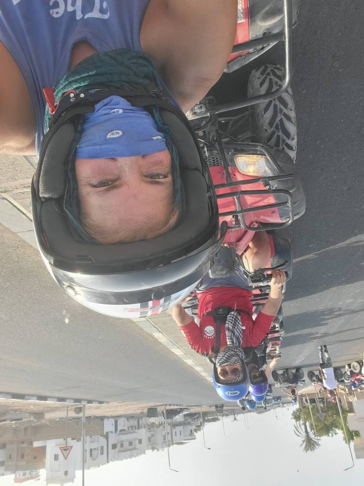 People riding quad bikes on a road adventure.