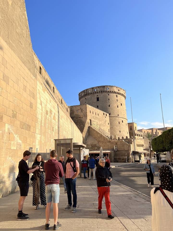 Group of people in front of a historical fort.