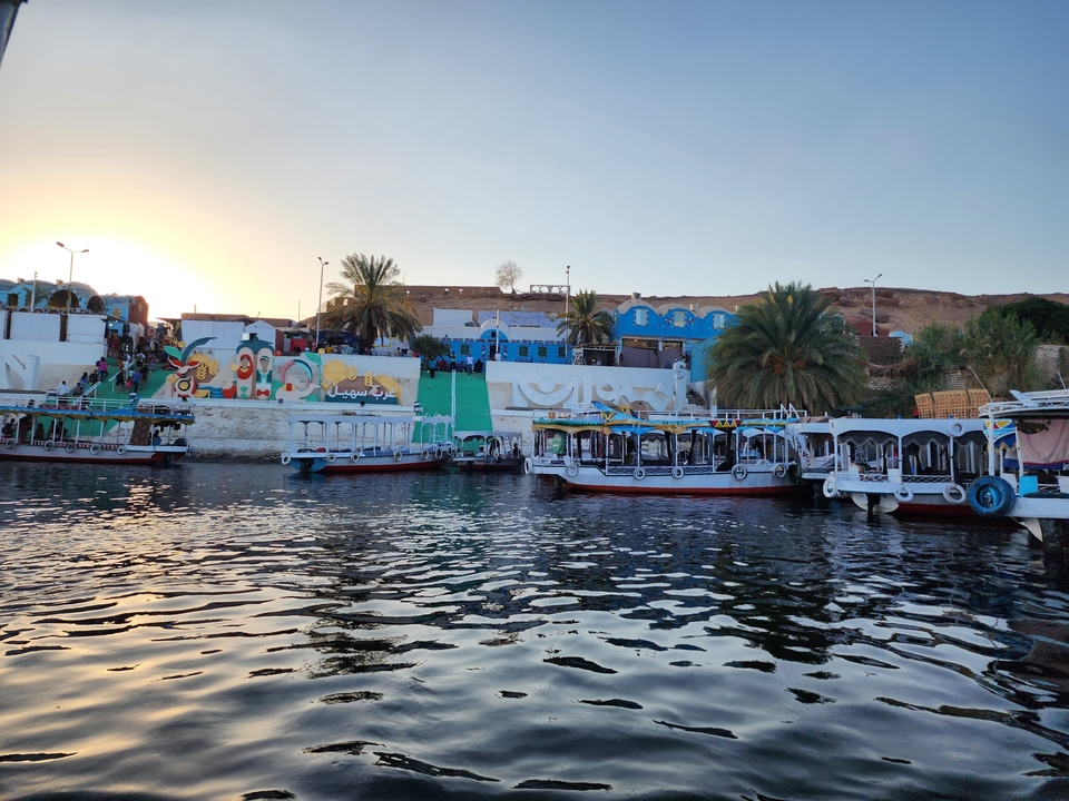 Colorful riverside buildings reflected in water.