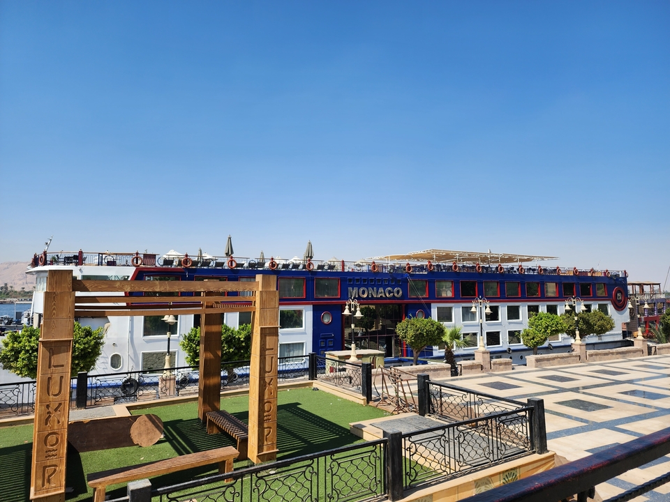 Cruise ship named Monaco docked at a port.