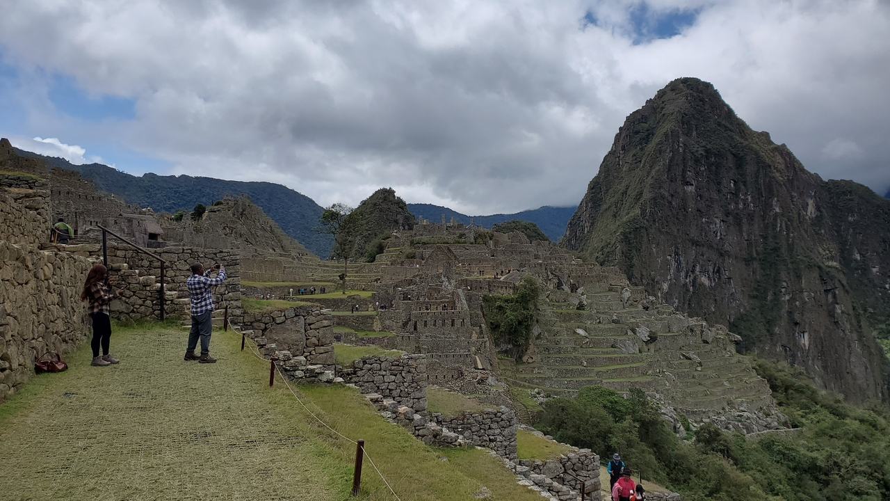 Tourists exploring the archaeological site of Machu Picchu.