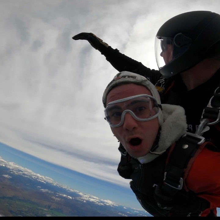 Person skydiving with a surprised expression.